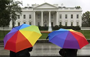 Prints of Sightseers holding umbrellas stop in front of the White House on a rainy day in Washington November 4, 2010 USA Prints: Sightseers holding umbrellas stop in front of the White House on a rainy day in