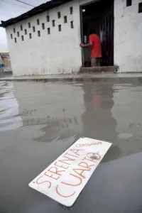 Mexico Prints: A sign reading Room for Rent floats in a flooded street after heavy rains in Cancun