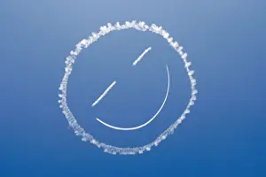 A sky writer draws a smiley face in the sky at start of Los Angeles County Air Show