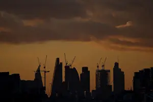 : Skyscrapers stand at sunset in the city of Londons financial district in London