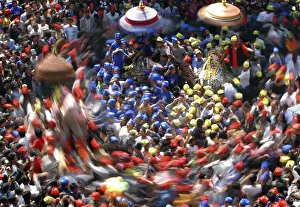 A slow motion picture of devotees carrying chariots as they participate in the Chariot