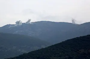 Smoke rises on the mountains as seen from Northern Afrin countryside
