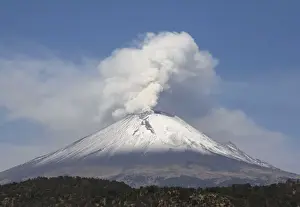 The snow-covered Popocatepetl volcano spews a cloud of steam high into the air in Puebla