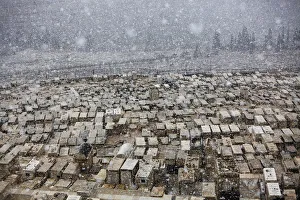 Prints of Snow falls on top of graves at the Mount of Olives cemetery in Jerusalem March 2, 2012. Snow fell in Jerusalem on Friday morning Israel Prints: Snow falls on top of graves at the Mount of Olives cemetery in Jerusalem