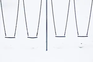 General Prints: Snow sits on childrens swings at a playground in Lyminge near Folkestone in southern