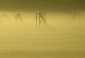 Soccer goal posts are seen in the autumn mist at Dukes Meadows in Chiswick, west London