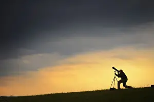 A spotter takes a picture of the solar-powered Solar Impulse 2 experimental aircraft