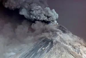 Steam rises from Fuego volcano (Volcano of Fire) as seen from San Juan Alotenango