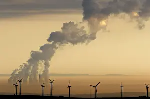 Steam rises from a power station behind the Royd Moor Wind Farm in Penistone