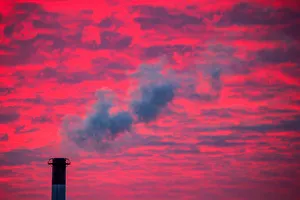 Dailylife Prints: Steam rises from a smoke stack at sunset in Lansing, Michigan