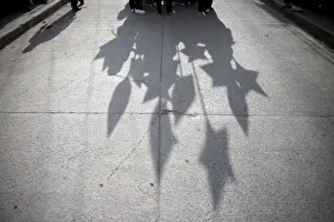 Students cast their shadows during a parade to celebrate Mothers Day in Chilapa de