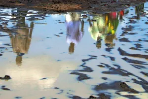 Sudan Prints: Sudanese are reflected in a pool of rain water in southern Sudan