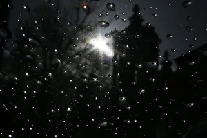 The sun is seen reflected in raindrops on a window after shower in London The sun is seen reflected in raindrops on a window after shower in London