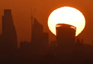 Images Dated 2018 May: The sun is seen rising over skyscrapers in the City of London financial district in