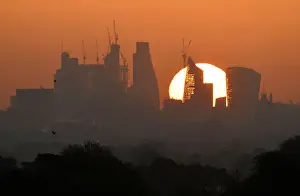 Weather Prints: The sun is seen rising over skyscrapers in the City of London financial district in