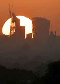 Weather Prints: The sun is seen rising over skyscrapers in the City of London financial district in