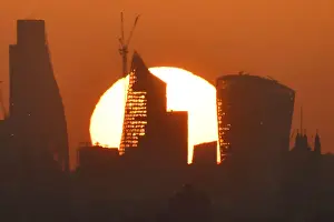 Weather Prints: Sun is seen rising over skyscrapers in the City of London financial district in London