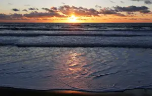 The sun sets over a beachfront along the Atlantic Ocean coast in Montalivet-les-Bains