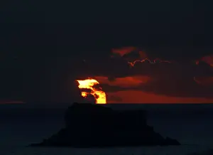 Malta Prints: The sun sets behind Filfla, a bird reserve and the southernmost island of the Maltese