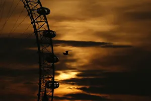 United Kingdom Prints: The sun sets behind the London Eye in central London