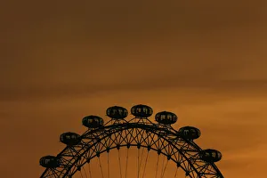 United Kingdom Prints: The sun sets behind the London Eye in central London