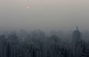 Prints of The sun sets above residential buildings on a hazy day in Beijing, September 20, 2014. REUTERS/Barry Huang/File Photo China Prints: The sun sets above residential buildings on a hazy day in Beijing