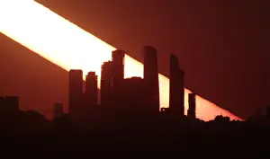 The sun sets behind the skyscrapers of the Moscow International Business Centre in Moscow