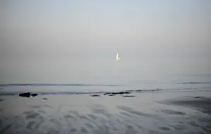 United Kingdom Prints: The sun sets on a small yacht in the north sea by a beach in Broadstairs in Kent