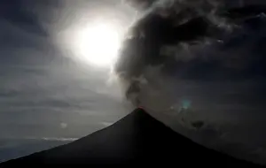 Lunar Prints: The super blue moon rises above the spewing Mayon Volcano during a mild eruption before a