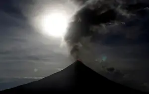 Lunar Prints: The super blue moon rises above the spewing Mayon Volcano during a mild eruption before a
