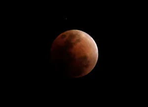 Lunar Prints: The super blue moon is seen during a total lunar eclipse in Legazpi