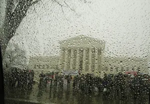 Weather Prints: The Supreme Court is seen from within a car as snow melts on the window during a light