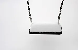 Weather Prints: A swing is covered in snow after a snowstorm in the town of Pajares