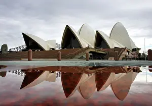 Sydneys landmark Opera House is reflected in a pool of rain water March 31, 2005