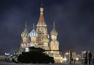 A T-34 Soviet-made tank and Russian servicemen take part in a rehearsal for a military