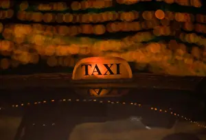 Religion Prints: A taxi drives through the street decorated with lights ahead of Tihar festival
