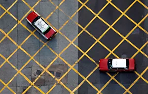 Taxis cross a street near Wan Chai station in Hong Kong