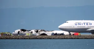 <b class=qtipBold><figcaption>TB3E9761PTXD5</figcaption></b><br>An airliner passes the wreckage of an Asiana Airlines Boeing 777 which crash landed at San Francisco International Airport in San Francisco, California July 6, 2013. REUTERS/Stephen Lam (UNITED STATES - Tags: DISASTER TRANSPORT) - RTX11F4O TB3E9761PTXD5