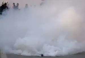 A tear gas shell fired by Indian police explodes during a protest march in Srinagar