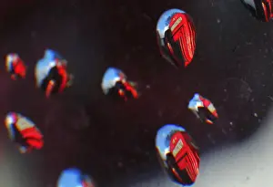Telephone boxes are reflected in raindrops in central London