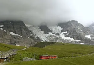 Swiss Prints: Tourists leave a train of the Jungfraubahn railways at the Kleine Scheidegg station