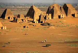 Tourists walks to the Royal Cemeteries of Meroe Pyramids in Begrawiya at River Nile State