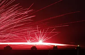 Tracer bullets ricochet off their targets as Japanese Ground Self-Defence Force tanks