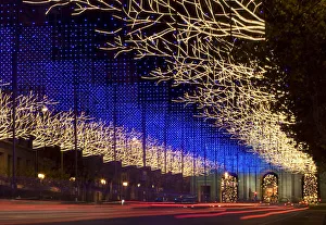 Traffic streams up Alcala street under Christmas lighting in central Madrid