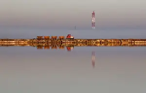Train drives across the bed of a drained area of the Sasyk-Sivash lake used for