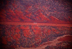 A truck drives along a road in the Pilbara region of Western Australia