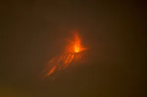 Ecuador Prints: The Tungurahua volcano spews lava as pictured from the city of Huambalo, Ecuador