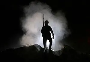 Mideast Prints: Turkey-backed Free Syrian Army fighter holds a weapon in the town of Tadef in Aleppo