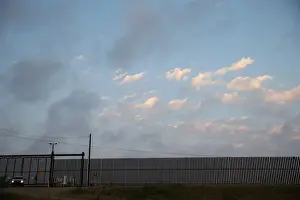 Prints of A U.S. Border Patrol agent guards a section of border fence by the Mexico-U.S. border in Hidalgo, Texas, U.S. April 13, 2018. REUTERS/Loren Elliott USA Prints: A U. S. Border Patrol agent guards a section of border fence by the Mexico-U. S