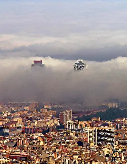 An unusual fog settles over Barcelonas city coastline